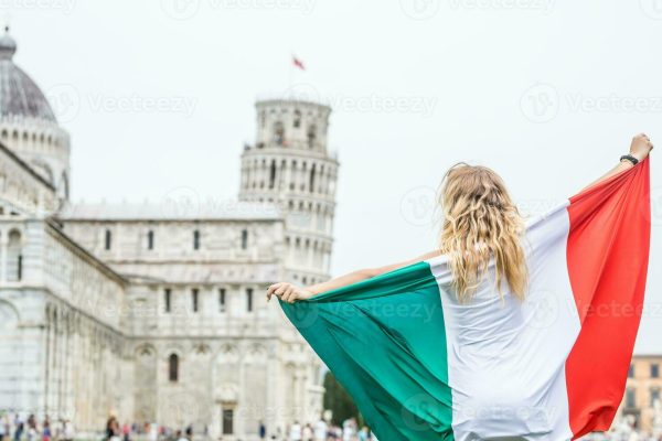 young-teen-girl-traveler-with-italian-flag-before-the-historic-tower-in-town-pisa-italy-photo